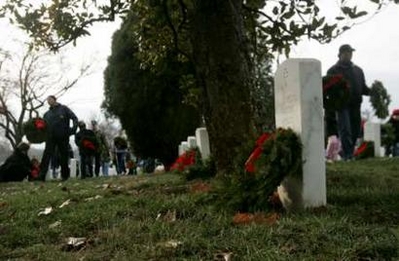 Volunteers carry holiday wreaths at Arlington National Cemetery in Virginia