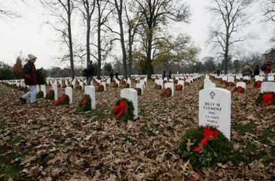 Volunteers place holiday wreaths at Arlington National Cemetery in Virginia