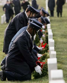 United States Air Force ROTC honor guard place holiday wreaths at Arlington National Cemetery in Virginia