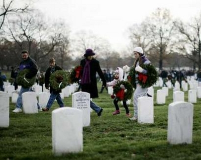A family walks among grave sites at Arlington National Cemetery in Virginia